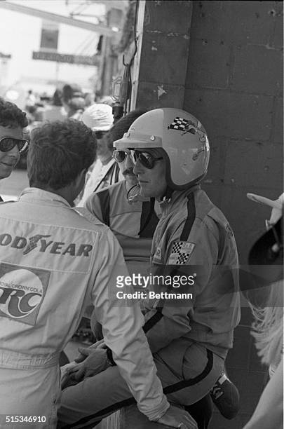 Paul Newman stands on the pit after qualifying a Porsche 911 for the 12 hour Sebring Road Race. Newman, who identifies himself as ‘P.L.' when racing,...