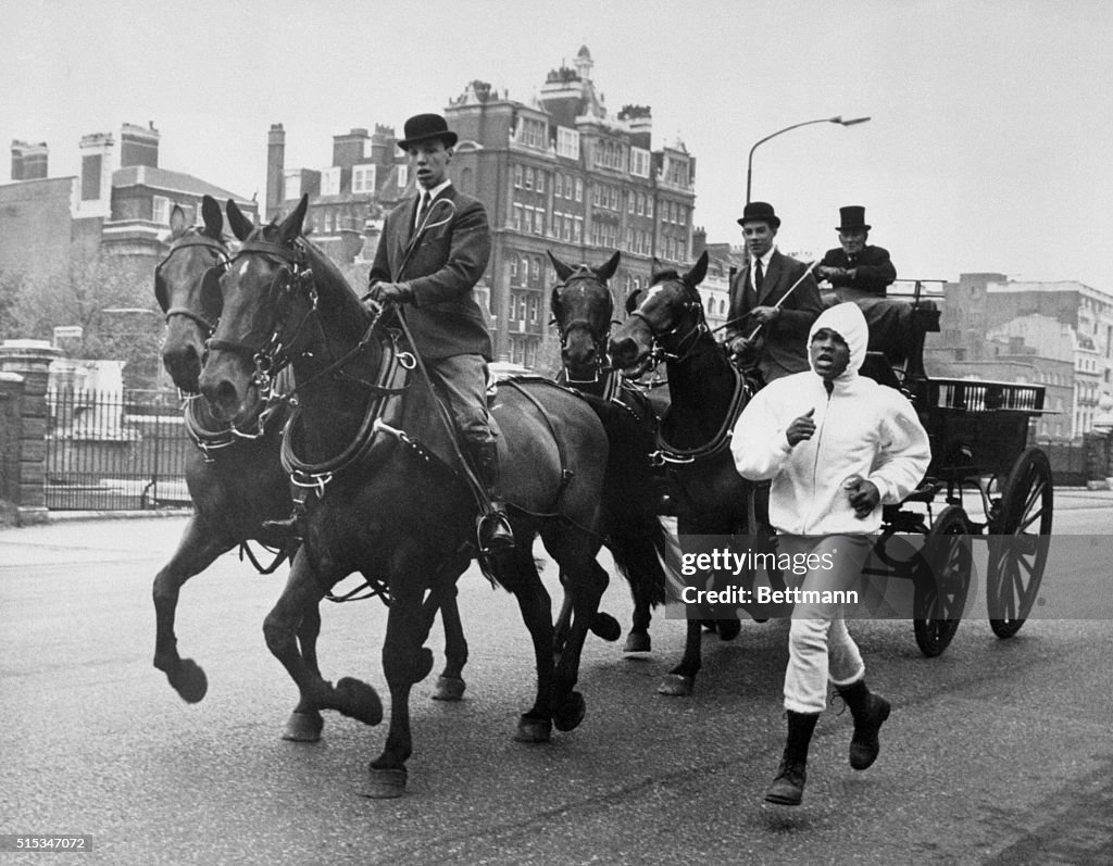 Cassius Rai Cassius Clay jogs beside a four-horse driven carriage during an early ...