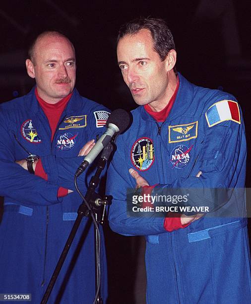 Space Shuttle Discovery French Mission Specialist Jean-Francois Clervoy talks to the media 06 December 1999 as US Pilot Scott Kelly listens upon...
