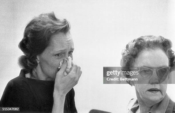 Mrs. Gertrude Beniszewski in custody of a police matron, weeps here early May 19th after a jury delivered a verdict of guilty against her and four...