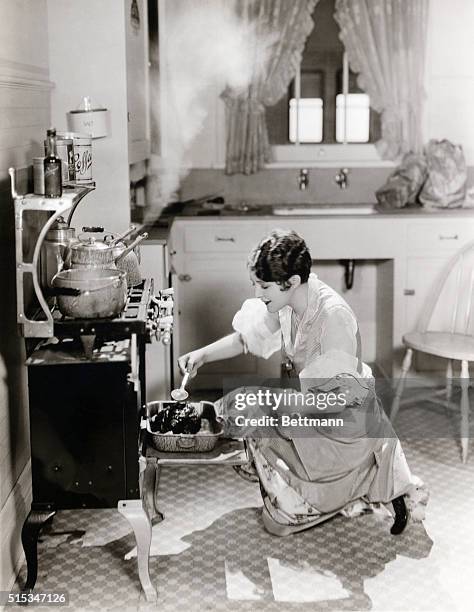 Woman basting turkey in a still from the 1927 motion picture "Affair of Follies."