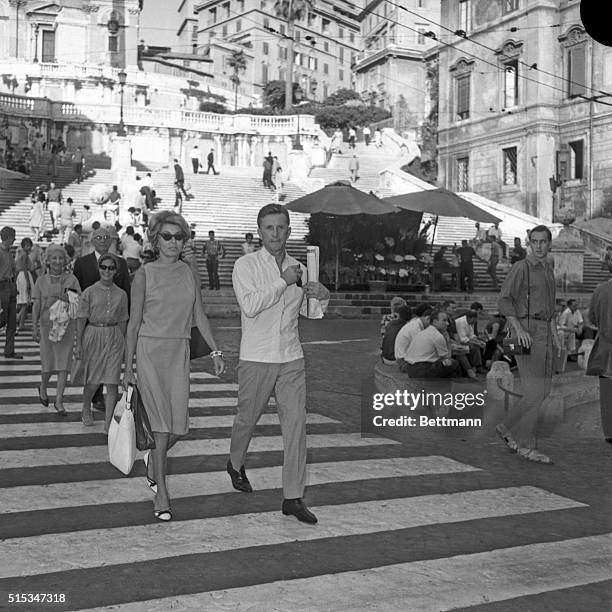 Actor Kirk Douglas and his wife, Anne Buydens, join the throngs of tourists walking through the Eternal City as they enjoy themselves window-shopping...