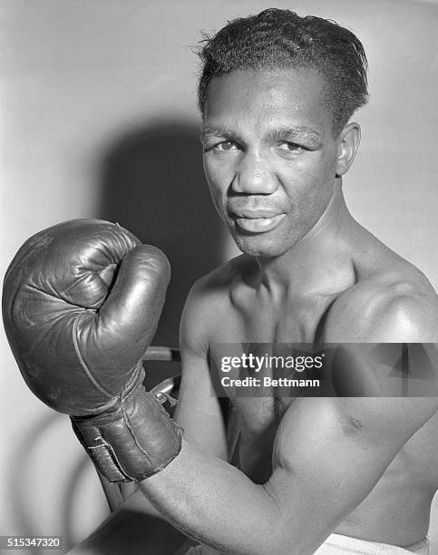 Chalky Wright menacingly displays the left hook with which he hopes to defeat Willie Pep in the battle for the Featherweight title at Madison Square...