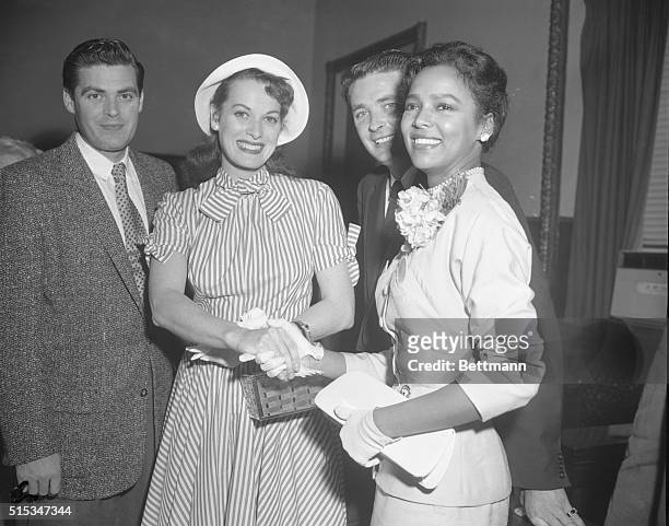 Screen star Maureen O'Hara, left, and singer Dorothy Dandridge shake hands in Hollywood court after testifying at the criminal libel trial of...