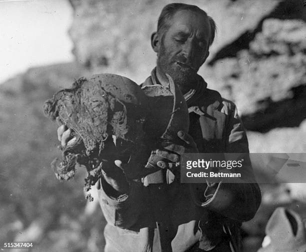 Paxson Hayes, explorer is pictured with the head of one of the 7 ½ foot tall mummies he discovered while on an exploration into the wilds of the...