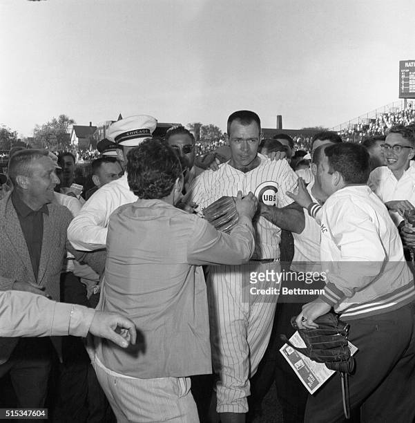 Yelling, happy, Chicago Cubs fans and team surround pitcher Don Cardwell on Wrigley Field here 5/15 after second game of doubleheader in which...