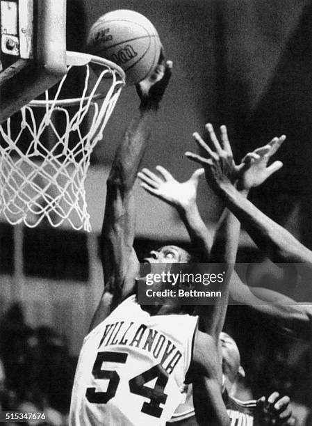 Villanova guard Ed Pinckney taps home a basket away from the outstretched hands of a Seton Hall defender during the first half of play at the Palesra...