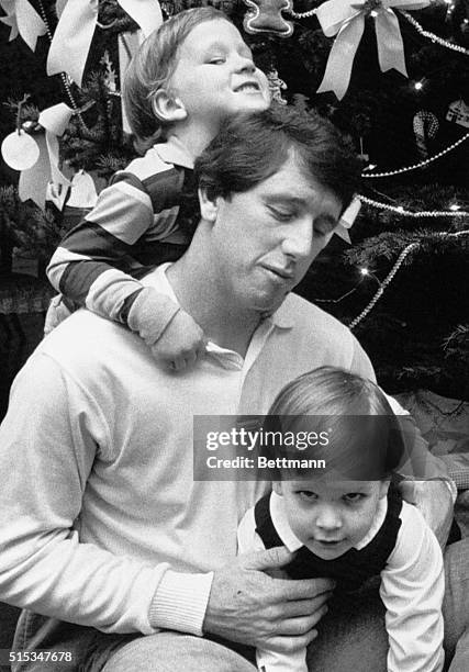 Archie Manning is gang tackled by his two sons, Cooper and Peyton at his home here after he had learned he was named UPI's NFC Player of the Year....