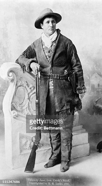 Calamity Jane , standing with rifle. Undated photograph.