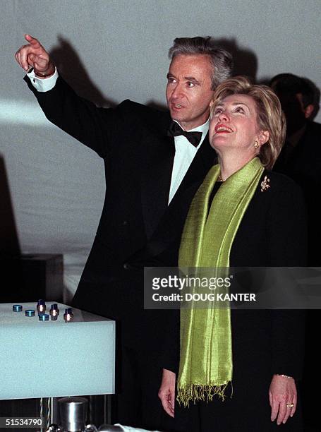 First Lady Hillary Rodham Clinton stands with Bernard Arnault as he points toward the new LVMH tower before the building's inauguration in New York...
