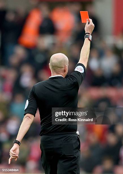 Referee shows a red card during the Barclays Premier League match between Stoke City and Southampton at the Britannia Stadium on March 12, 2016 in...