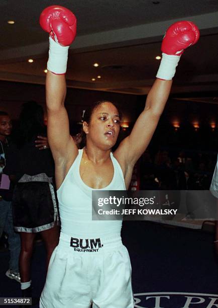 Laila Ali raises her arms after defeating Nicolyn Armstrong during the second round of their fight at Cobo Hall in Detroit on 10 December 1999. Ali...