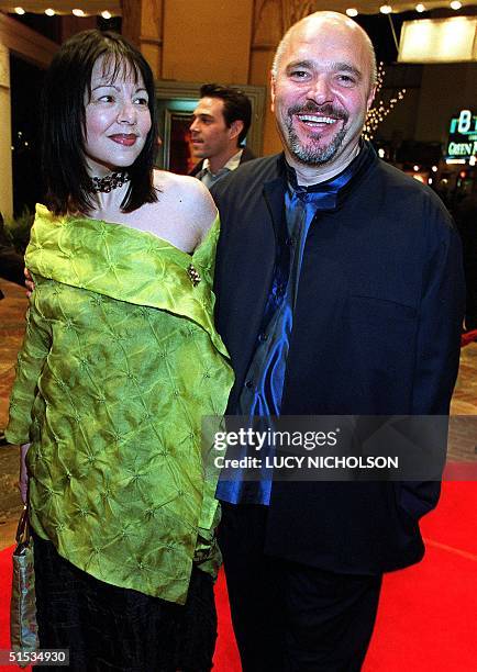 British writer-director Anthony Minghella arrives at the premiere of his new film "The Talented Mr Ripley" with his partner Caroline Chowa , in Los...
