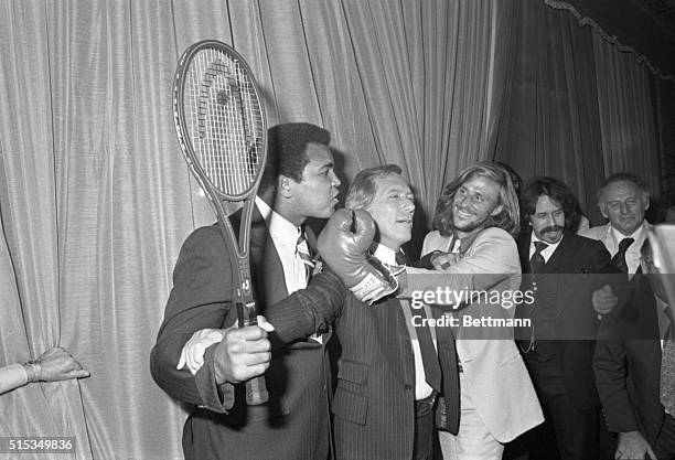 Singer Andy Williams tries to separate the two champs Muhammad Ali and Sweden's Bjorn Borg has just won the Wimbledon Men's Singles Title for the...