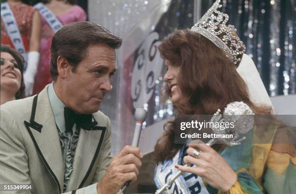 Miss Universe of 1972, wearing her crown and carrying her sceptre, Miss Kerry Anna Wells of Perth, Australia, talks with the Master of Ceremonies of...