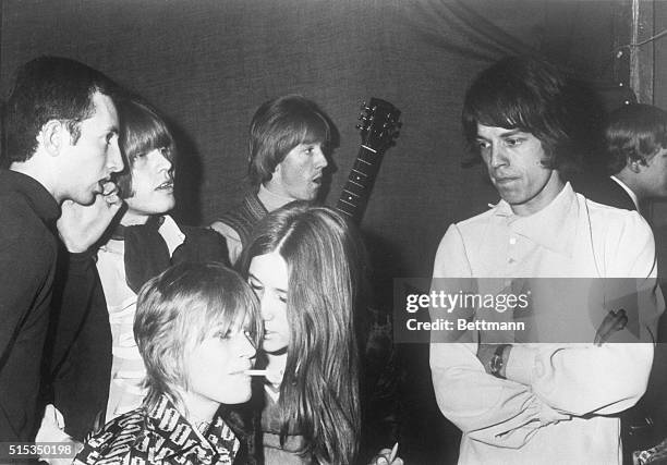 London, England- A pensive Mick Jagger, lead singer with Britain's "Rolling Stones," looks down at his girlfriend, actress Marianne Faithfull...