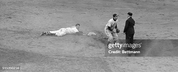 Boston, MA: Phil Masi, Boston Braves catcher is safely back on second in the eighth inning of the first game of the World Series. Feller threw to...