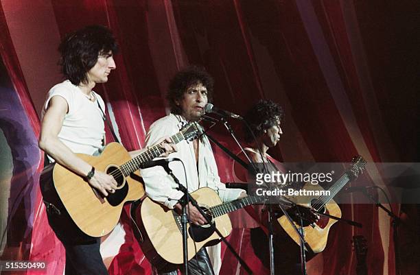 Philadelphia, Pennsylvania-The Live Aid Concert at JFK Stadium. Left to right: Rolling Stone Ron Wood plays bass, Bob Dylan strums guitar and Keith...