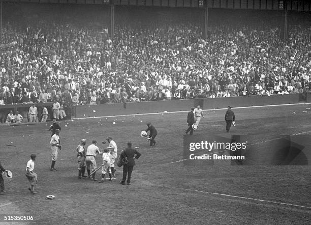 Photo shows Lou Gehrig and Babe Ruth crossing the plate on the Babe's 49th circuit smash of the season which came in the hectic eighth inning of...