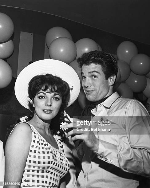 American actor Warren Beatty with English actress and fiancee Joan Collins at a Hollywood charity event.