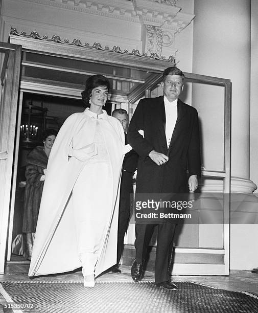 Washington, D.C.: Full length shot of President and Mrs. John F. Kennedy as they left the White House to attend a series of inaugural balls. Five...