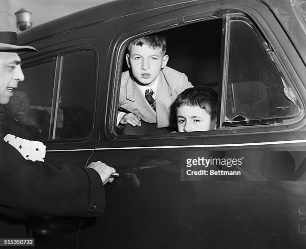 Michael and Robert Rosenberg, the two sons of executed spies Julius and Ethel Rosenberg, look out from a car.