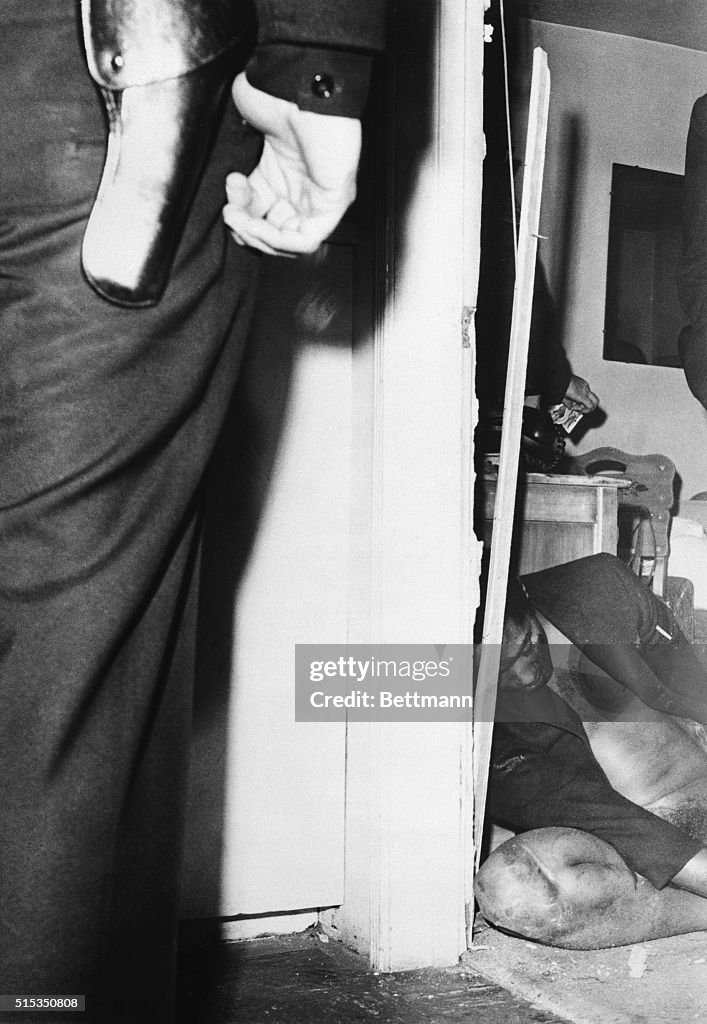 The body of singer Sam Cooke lies slumped in the doorway of a motel