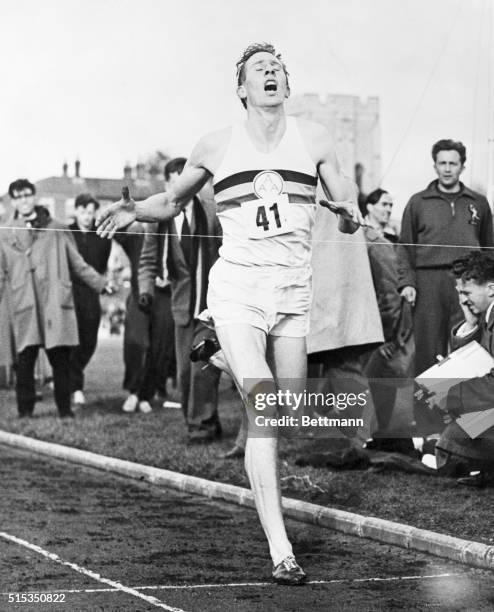 Oxford, England: Mouth wide open gasping in air, with every tendon tight as a fiddle string, 24-year-old English medical student Roger Bannister is...