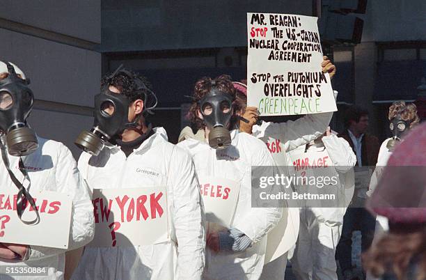 Washington, DC- Members of Greenpeace, wearing gas masks and white coveralls, demonstrate outside the National Press Club during a speech by Japanese...