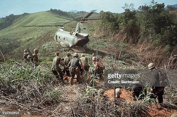 Vietnam- Wounded US Marines are shown heading for a helicopter after an 11-day battle. They are preparing to evacuate the area.