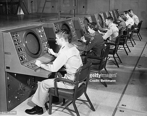 Manning tracking consoles which monitor early warning information received by the Missile Master system at Fort George G. Meade, Maryland are...