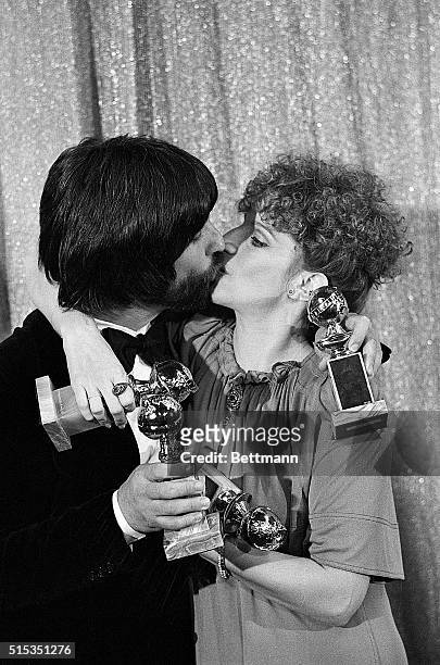 Hollywood,CA- A tangle of four Golden Globe awards Barbara Streisand plants a big kiss on John Peters who is producer of the film "A Star is Born"....