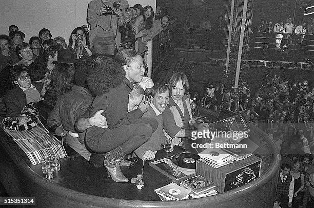 Singer Diana Ross, squatting atop disc jockey booth in Studio 54, entertains merrymakers at farewell party for co-owners Steve Rubell and his...