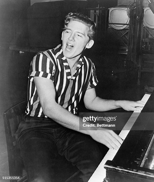 Portrait of rock-and-roll recording artist Jerry Lee Lewis. He is shown seated at the piano, singing.