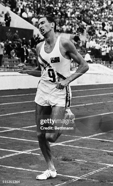 Rome, Italy- OLYMPICS. Australian Herb Elliot hits the tape far ahead of the field to win the 1,500-meter run here, Sept. 6th. The fleet Aussie...