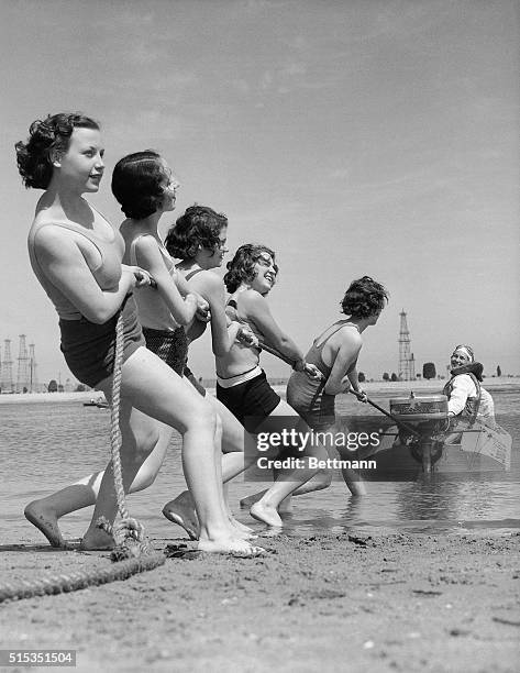 Long Beach, CA-ORIGINAL CAPTION READS: speed boat aces prepare for the "Champions' Day" races at Long Beach, CA. With Loretta Turnbull, world's...