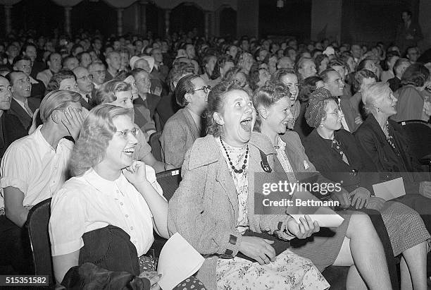 Berlin, Germany- A row of German women laugh heartily as they see Charlie Chaplin's imitation of Hitler making a speech in the movie "The Great...