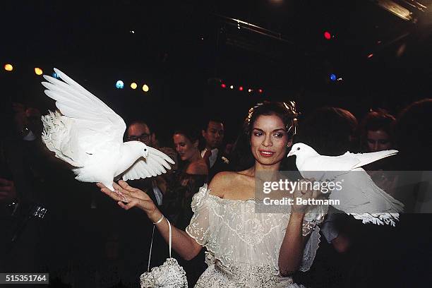 Model Bianca Jagger holds doves while at a party thrown by fashion designer Halston at Studio 54.