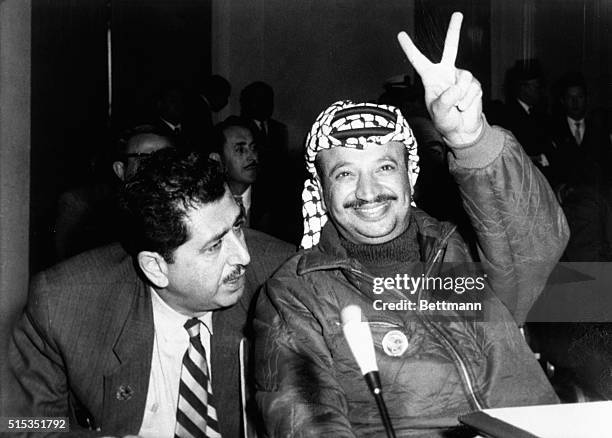 Rabat, Morocco Yasser Arafat, leader of the Palestine guerrillas, flashes a "V" at the opening of the Arab Summit Conference in Rabat, December 21....