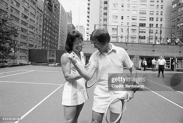 Bobby Riggs flexes his biceps in an attempt to intimidate Billie Jean King. The two played against each other September 20, 1973. King won the match...