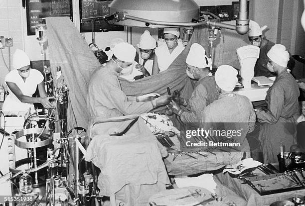 Cape Town, South Africa- View of members of Dr. Christiaan Barnard's surgical team performing an open heart surgery in the theater where the now...