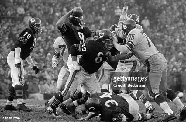 Chicago, IL- Chicago Bear Quarterback, Bill Wade , cocks his arm amidst onrushing Giants as Bob Wetoska blocks. Wade scored 2 touchdowns to lead the...
