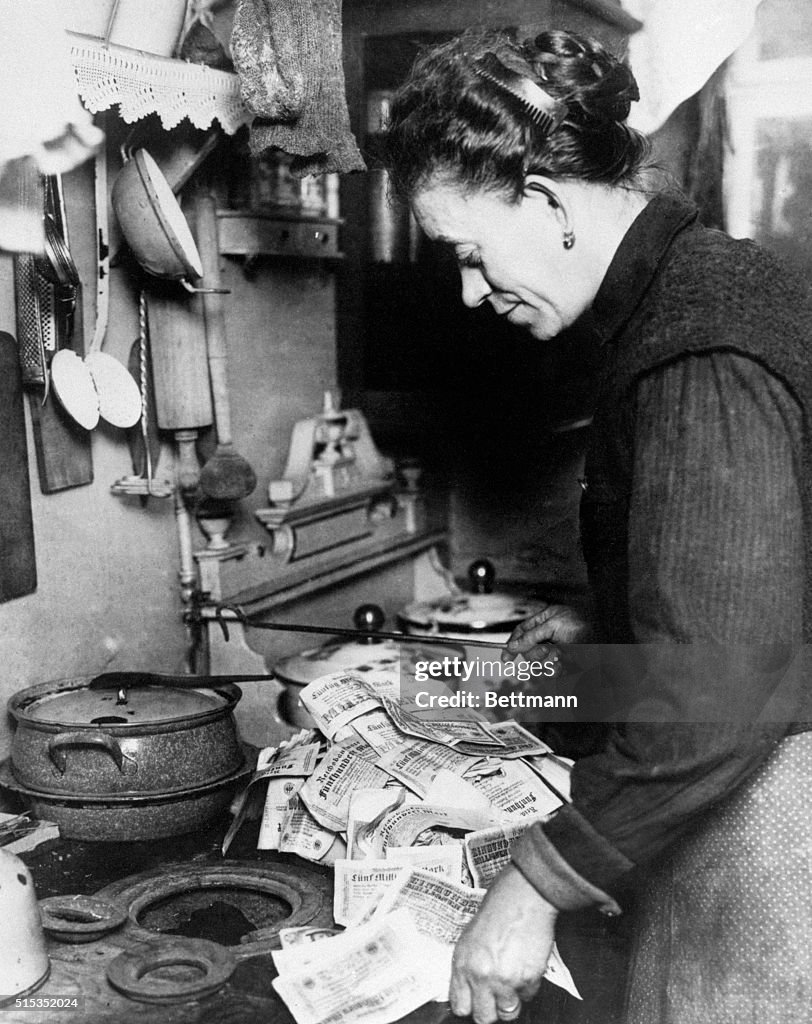 Woman Lighting Fire with German Money