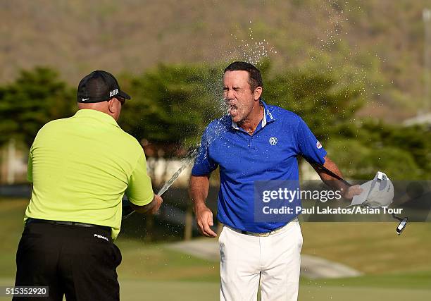 Scott Hend of Australia is sprayed with champagne on the 18th green after his win during round four of the True Thailand Classic presented by Chang...