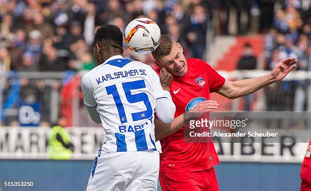 Boubacar Barry of Karlsruher SC challenges Kevin Kraus of 1. FC Heidenheim during the second bundesliga match between Karlsruher SC and 1. FC...
