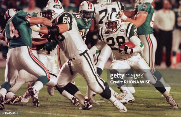 New York Jets' center Kevin Mawae blocks Miami Dolphins' linebacker ach Thomas to give teammate running back Curtis Martin room to get the first down...