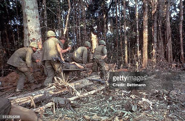 Dak To, South Vietnam: Plasma is given to a wounded member of the 173rd Airborne Brigade on Hill 875 as he is carried on a stretcher through the...