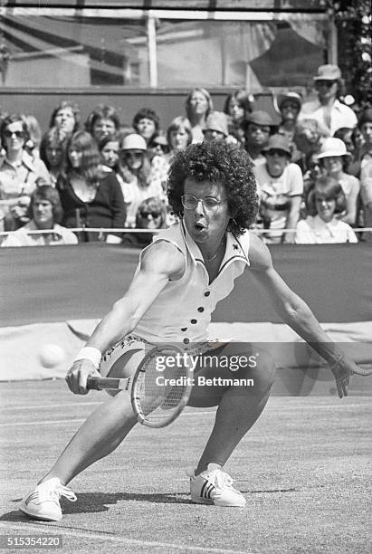 Wimbledon, England- Five times champ at Wimbledon, Billie Jean King seems to be talking to the ball, as she crouches low to reach the ball, during...