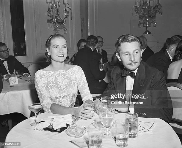 New York, NY- Actress Grace Kelly and designer Oleg Cassini are pictured attending a party given by hotel owner Julius Fleischman for Tallulah...