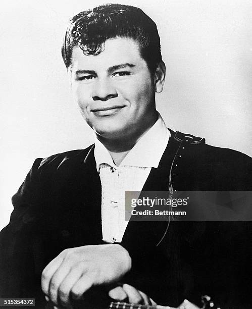 Portrait shows Ritchie Valens with his hands resting on his guitar, circa 1958. Undated head-and-shoulders publicity photo.